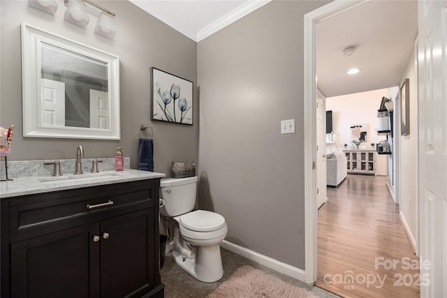 bathroom with toilet, crown molding, and vanity