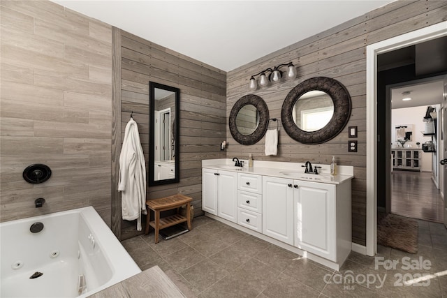 bathroom featuring tile patterned flooring, wooden walls, vanity, and a bathing tub