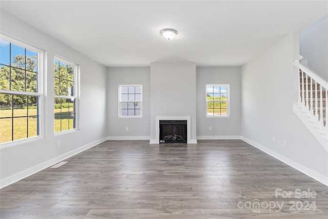 unfurnished living room with dark hardwood / wood-style flooring