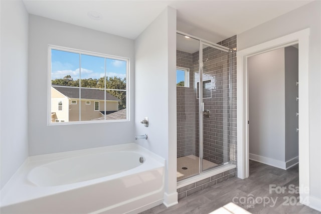 bathroom with separate shower and tub and hardwood / wood-style floors