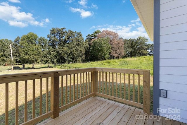 wooden deck featuring a yard