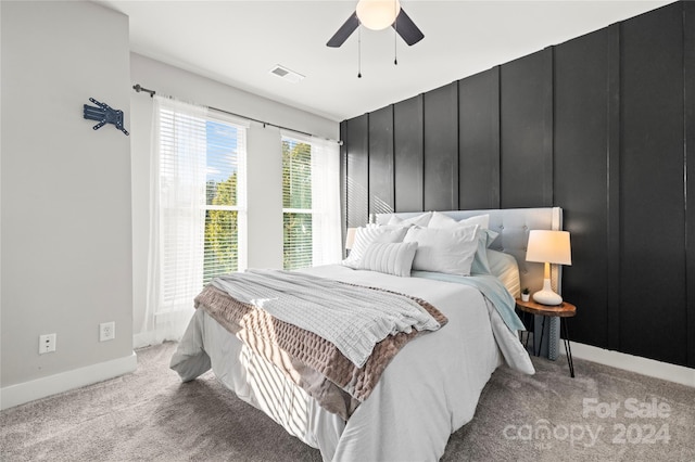 bedroom with light carpet and ceiling fan