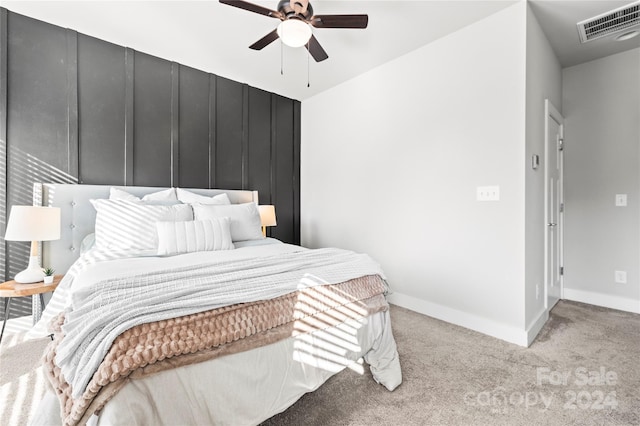 unfurnished bedroom featuring ceiling fan and light carpet