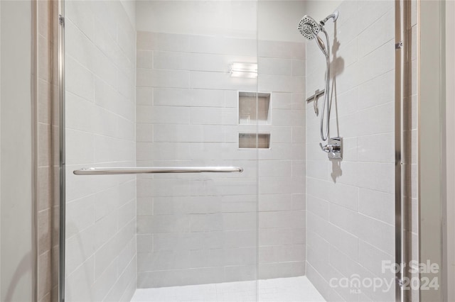 bathroom with a shower with shower door