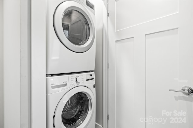 laundry area featuring stacked washer / drying machine