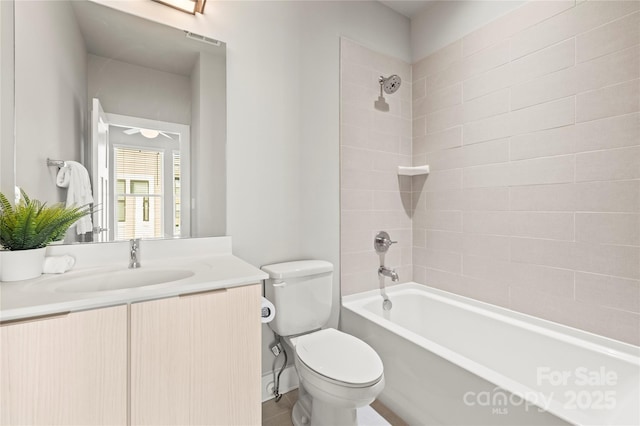 full bathroom with vanity, toilet, and tiled shower / bath combo