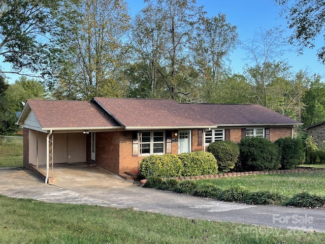 ranch-style house with a front lawn and a carport