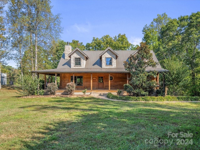 view of front of home with a front yard and covered porch