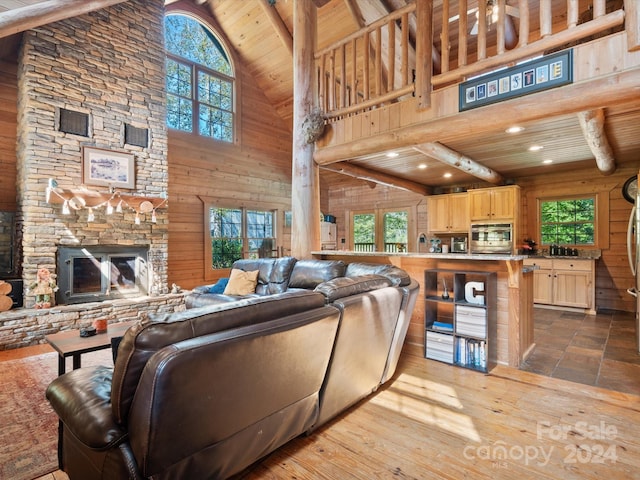 living room featuring beamed ceiling, high vaulted ceiling, wooden ceiling, and light hardwood / wood-style floors