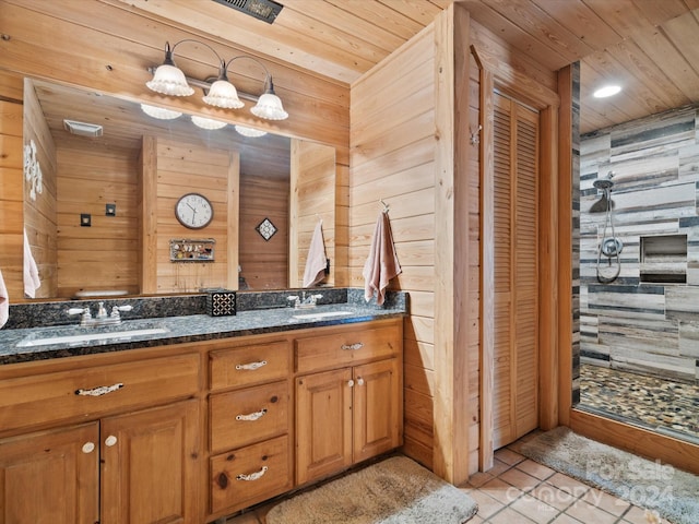 bathroom featuring tile patterned floors, vanity, wood walls, and wooden ceiling