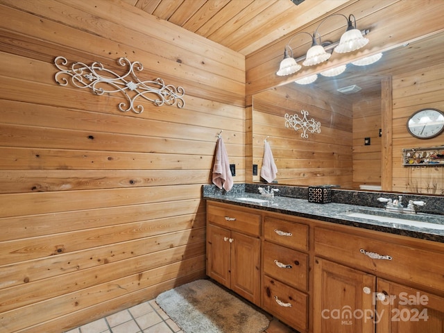 bathroom featuring wood walls, wood ceiling, tile patterned flooring, and vanity