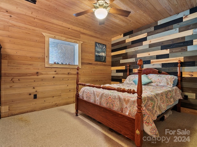 bedroom with carpet floors, wooden ceiling, wooden walls, and ceiling fan