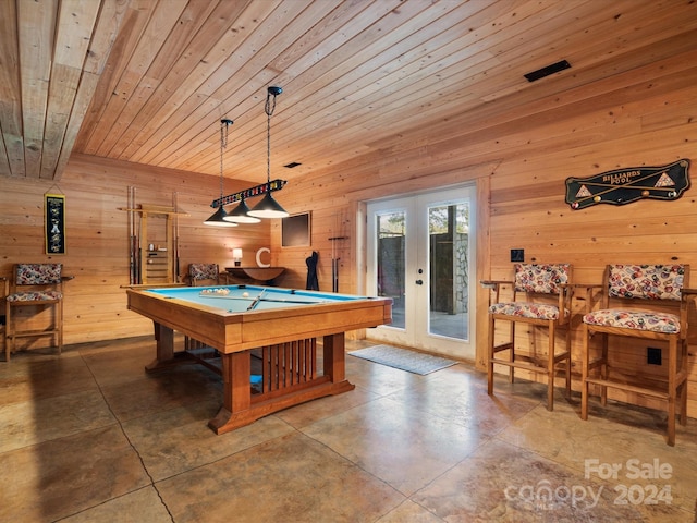 playroom with pool table, wood ceiling, wooden walls, concrete floors, and french doors