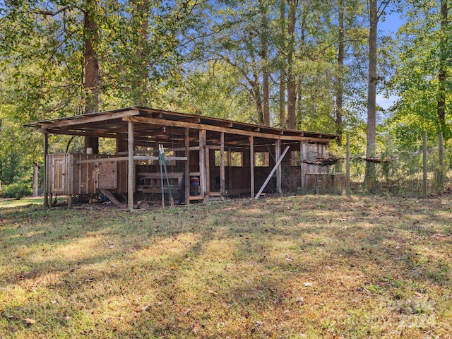 view of outdoor structure featuring a lawn