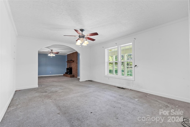 unfurnished living room featuring ornamental molding, carpet, and a textured ceiling