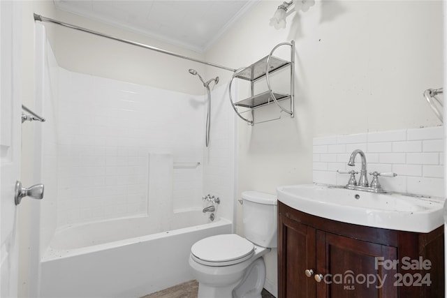 full bathroom featuring decorative backsplash, washtub / shower combination, vanity, ornamental molding, and toilet