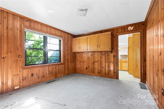 spare room featuring wooden walls