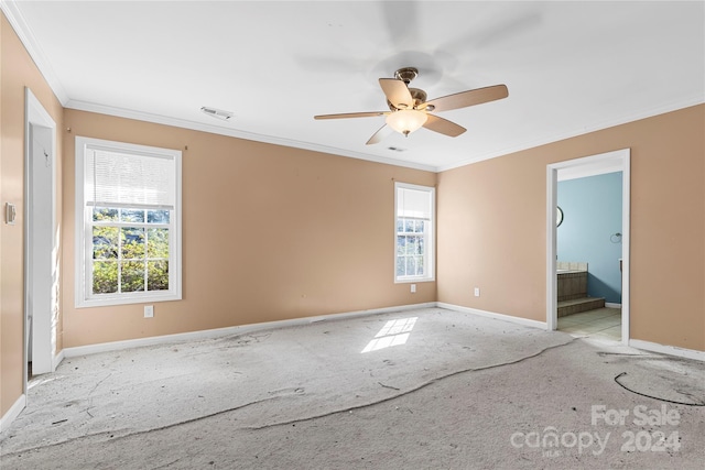 empty room with ceiling fan, a healthy amount of sunlight, and crown molding