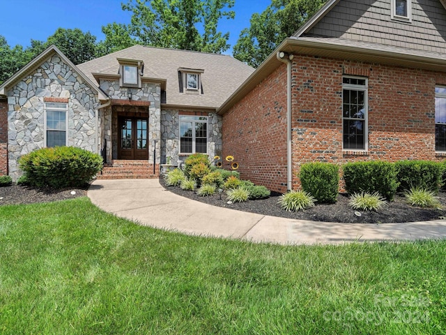 view of front of home featuring french doors and a front yard