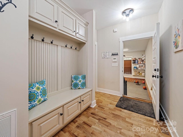 mudroom with light hardwood / wood-style flooring