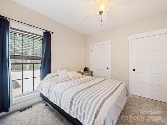 bedroom featuring ceiling fan and light colored carpet