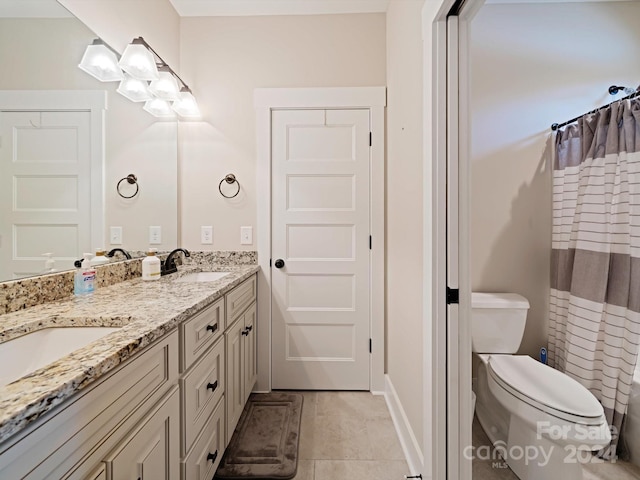 bathroom with tile patterned floors, vanity, and toilet