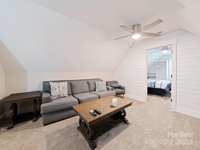 living room with ceiling fan, vaulted ceiling, and light colored carpet