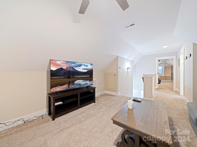 carpeted living room featuring ceiling fan and vaulted ceiling