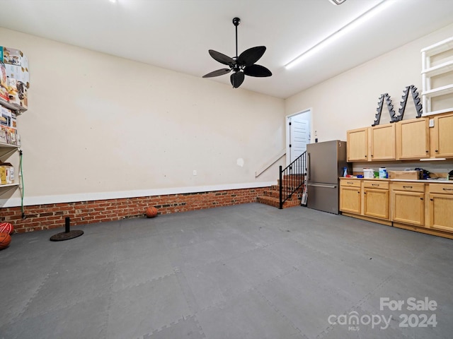 garage featuring stainless steel fridge and ceiling fan