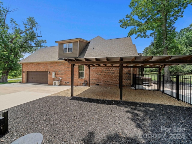 exterior space with a carport and a garage