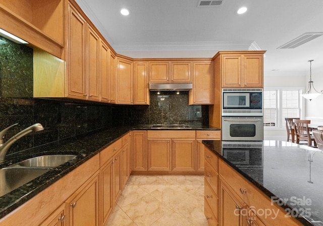 kitchen featuring tasteful backsplash, crown molding, stainless steel oven, and dark stone counters