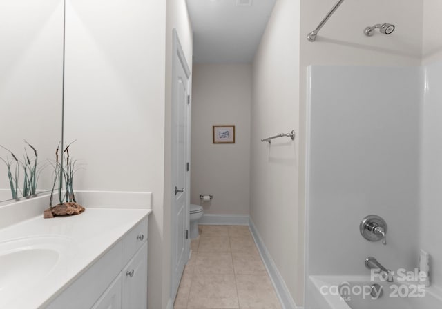 full bathroom featuring toilet, vanity, tile patterned floors, and shower / washtub combination