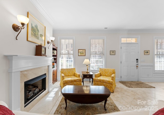 living room featuring a high end fireplace and ornamental molding