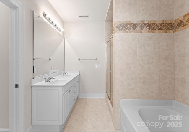 bathroom featuring tile patterned flooring, shower with separate bathtub, and vanity