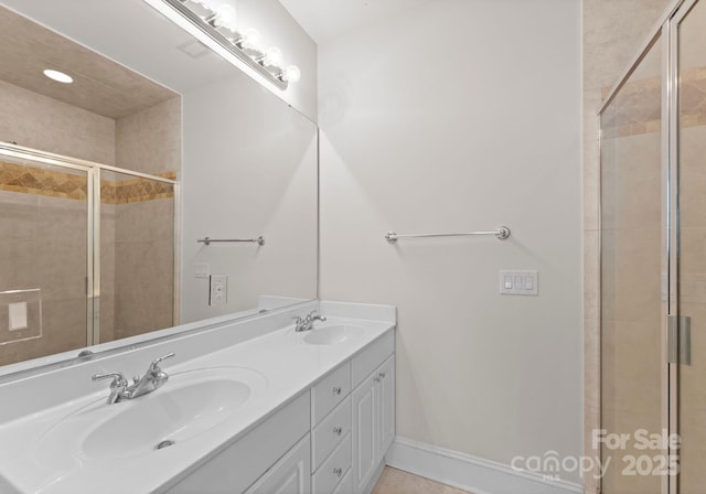 bathroom featuring tile patterned floors, vanity, and a shower with shower door