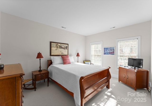 bedroom featuring light colored carpet