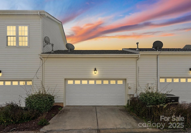 property exterior at dusk with a garage