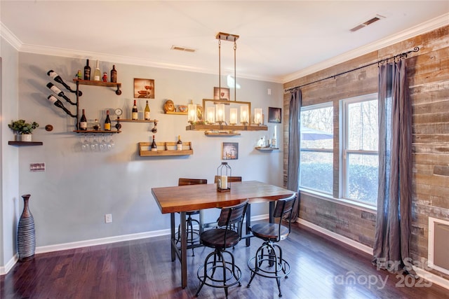 dining room with ornamental molding, plenty of natural light, and dark hardwood / wood-style flooring