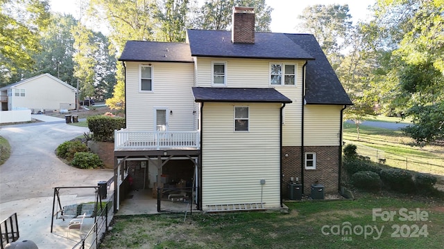 rear view of property with cooling unit