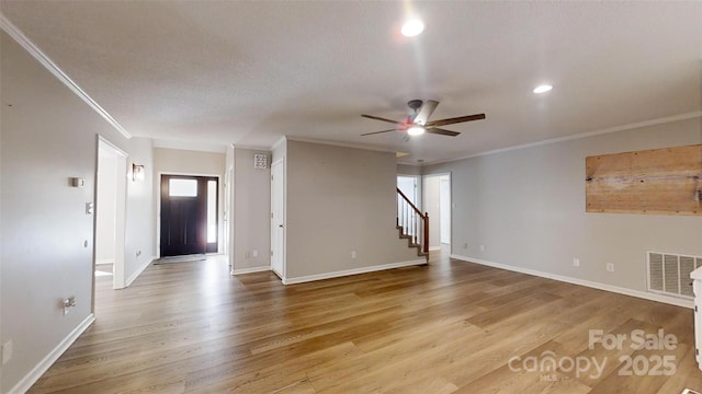 interior space featuring stairway, ornamental molding, visible vents, and light wood finished floors