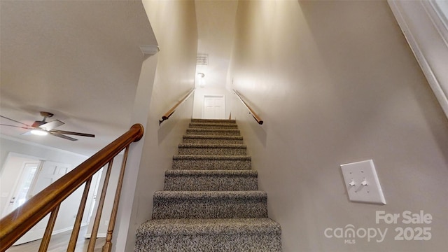 stairs with a ceiling fan