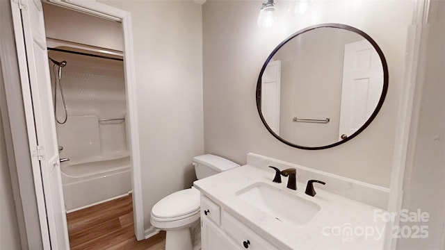 bathroom featuring shower / tub combination, vanity, wood finished floors, and toilet