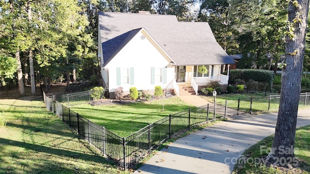 view of front of home featuring a fenced front yard, a front lawn, and covered porch