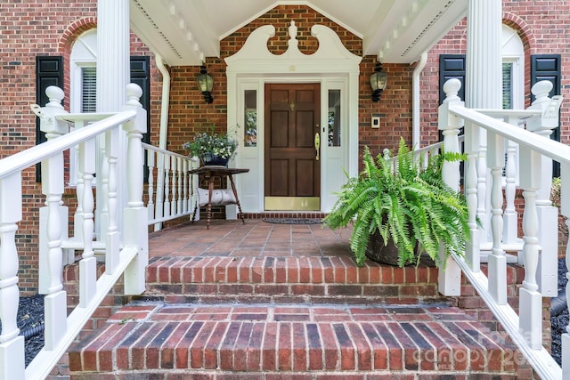 view of exterior entry with a porch