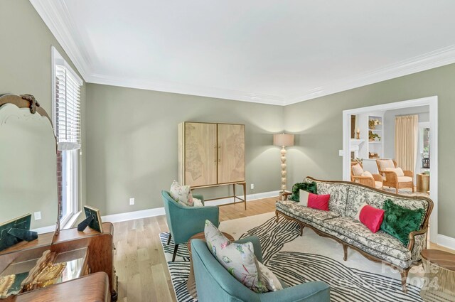 living room featuring light hardwood / wood-style flooring and ornamental molding