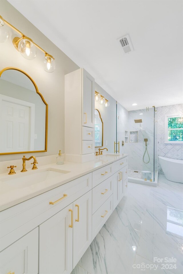 bathroom featuring vanity and independent shower and bath