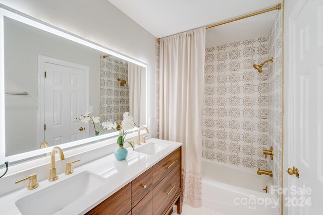 bathroom with shower / tub combo and vanity