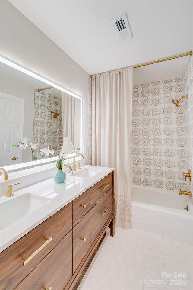 bathroom featuring tile patterned flooring, shower / tub combo with curtain, and vanity