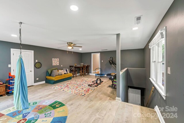 recreation room with light wood-type flooring and ceiling fan