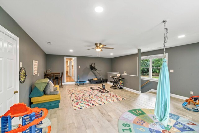 game room with light hardwood / wood-style flooring and ceiling fan